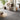 Light grey herringbone vinyl floor tiles laid in a parquet-style pattern