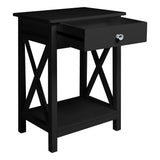 Black wooden bedside table nightstand with open shelf, drawer, and X-style legs.