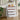 White 4-tier storage cabinet with lower drawers pulled out, brown rails
