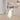 White folding dog playpen fence with tall vertical bars, dog resting inside