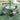Outdoor dining table with mirrored glass top and 4 matching dark mesh chairs