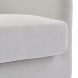 Cream fabric armchair armrest with rounded edge and upholstered seat.
