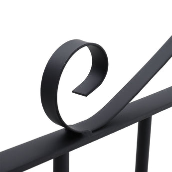 Close-up of black arched metal gate bar and vertical frame