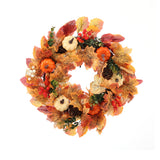 Orange autumn Halloween wreath with mixed leaves, berries, acorns, and pumpkin figurines