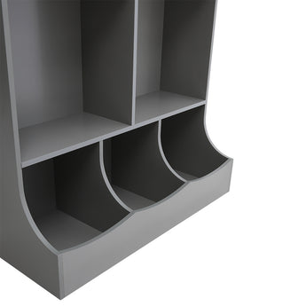 Grey close-up of curved lower bins in open toy storage cabinet with open side bays