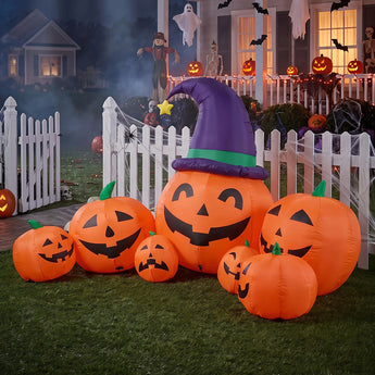 Inflatable Halloween yard decoration with orange jack-o'-lanterns and purple witch hat