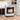 White compact indoor heater with regulator, front grille and glowing heating element