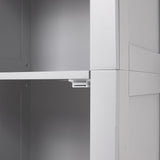 Close-up of white cabinet door hardware and hinge mechanism