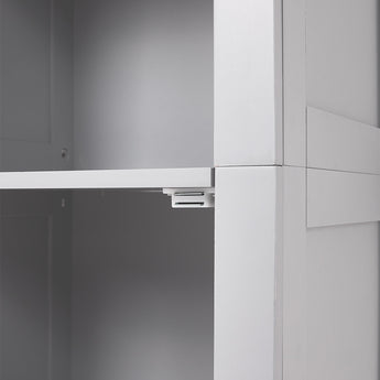 Close-up of white cabinet door hardware and hinge mechanism