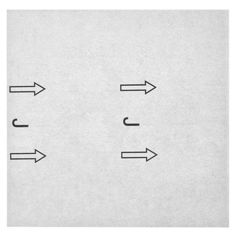 Light gray peel-and-stick PVC floor tile backing with alignment arrows for installation