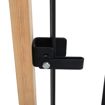 Black gate latch handle with mounting hardware on wooden post