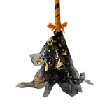 Halloween broom decoration close-up: orange bow, black star netting, tulle bristles