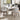 Modern set of 2 upholstered dining chairs in grey, curved back and cushioned seat