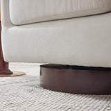 Cream armchair armrest and seat with dark circular swivel base.