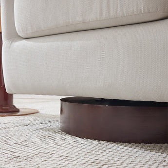 Cream armchair armrest and seat with dark circular swivel base.