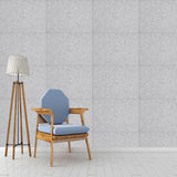 Silvery grey acoustic panel tiles on wall in a rectangular grid pattern