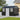 Anthracite metal storage shed with centered double door and window panels
