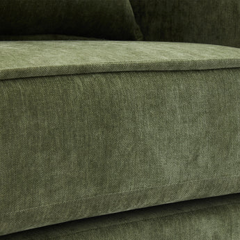 Close-up of green chenille upholstery fabric on the armchair seat