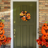 Halloween wreath with autumn leaves and pumpkin, ghost, and bat accents