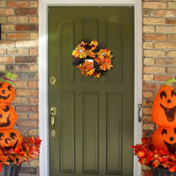 Halloween wreath with autumn leaves and pumpkin, ghost, and bat accents
