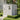 Light gray plastic storage shed with double doors and window outdoors