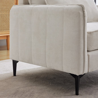 Linen sofa armchair side view in off-white fabric with tufted back panel and black legs
