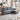 Grey chenille L-shaped 3-seater sofa with cup-holder armrests and metal rivet trim