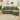 Green L-shaped corner sofa with chaise and three back cushions, front view in living room.