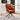 Rust-orange high-back accent chair with padded seat and black star swivel base