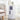 White round storage unit with three drawers and circular knobs, dark panel inserts