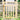 Light wood gate with X-brace cross lattice and vertical picket bars, front view