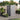 Grey plastic garden storage shed with open front door, window panel, pent roof