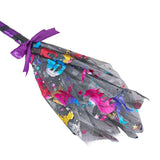 Close-up of purple-striped Halloween wand with silver tulle pouch and ribbon bow