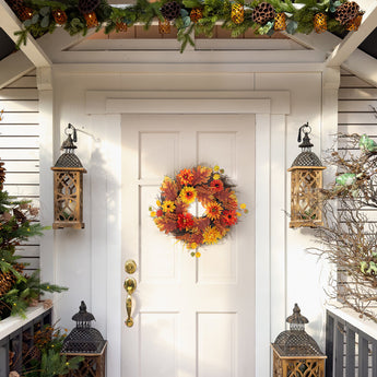 Halloween autumn wreath with orange and yellow flowers, hung on a front door