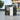 Open metal storage shed with flat roof, dark gray frame and light gray interior wall panels