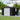 Metal storage shed with double doors, side window panel, and roof vents