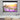 Electric projector screen showing a purple flower field with sunset glow