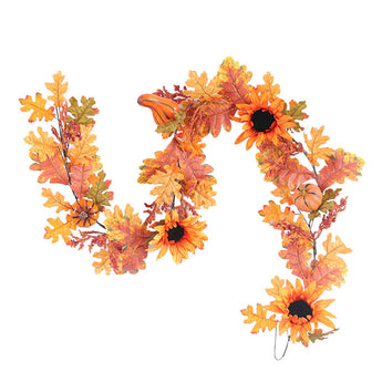 Orange autumn leaf garland with black-centered flowers and small acorns, looping design