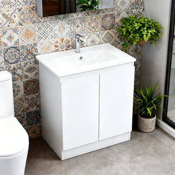 White freestanding bathroom vanity with built-in ceramic sink and two-door front storage