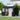 Anthracite metal storage shed with open double doors, window panels, and ramp brace