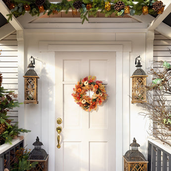 Halloween wreath with orange leaves, pinecones, and pumpkin decor centered on door