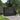 Black 239.5cm outdoor storage shed with double doors and louvered side panels