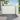 White retractable privacy awning with gray aluminum frame, handle and durable design