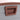 Brown plastic waterproof storage box side latch handle with vented slot cutout
