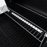 Close-up of charcoal BBQ cooking grate and firebox bars over the grill surface