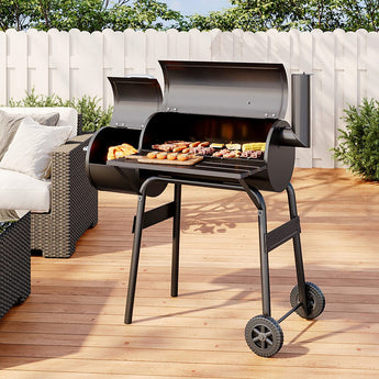 Charcoal BBQ grill with offset smoker, open lid and cooking grate, on wheeled stand