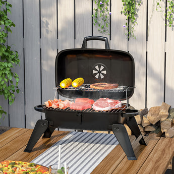 Portable mini charcoal BBQ grill with lidded firebox and two cooking grates, black