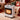 Compact electric heater with wheels, front grill and top controls, heating element lit