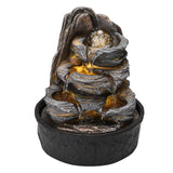 Front view of tiered tabletop fountain with LED-lit cascade and dark stone-texture base