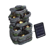 Faux rock garden fountain with lights, glowing light points in recessed stone basins.